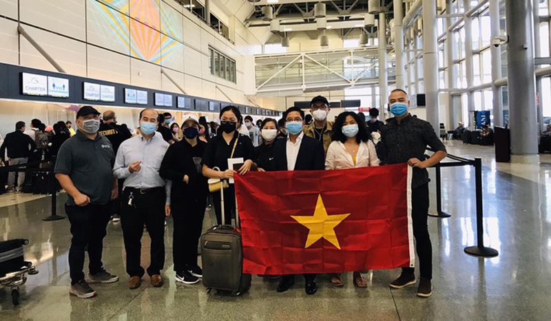 Vietnamese citizens pose for a photo before their depature