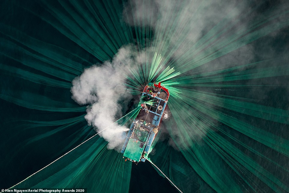 Organisers of the Aerial Photography Awards this year receive thousands of entries from 65 countries worldwide. Among the winning shots that most impressed viewers was a submission by Vietnamese photographer Hien Nguyen in the People category. The image depicts smoke pouring from the engine of a boat that belongs to anchovy fishermen working along the Phu Yen coastline, with their green nets illuminated under the water.
