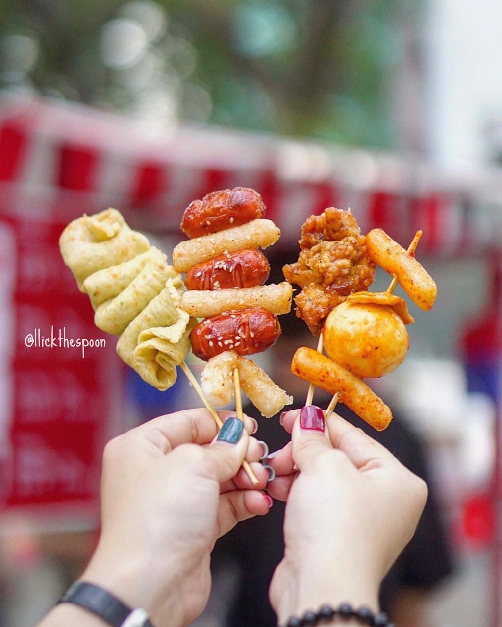 The menu includes delicacies such as tokbokki, roll vermicelli, fish balls, fried chicken balls, and sausages, with prices at around VND25,000, equivalent to US$1.08. (Photo: llickthespoon)
